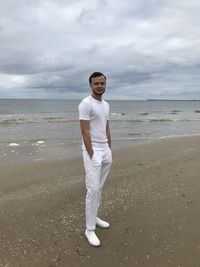 Full length portrait of man standing on beach