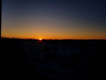 Scenic view of silhouette landscape against clear sky during sunset