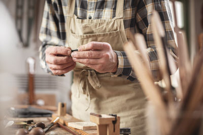 Close-up of man working on wood