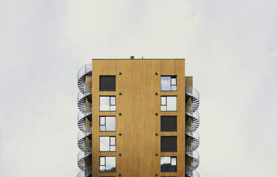 Modern residential building with wood cladding and spiral emergency stairs. lillehammer, norway. 