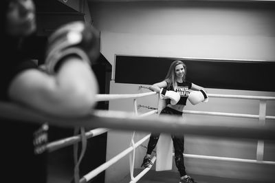 Portrait of young woman with friend standing in ring