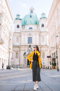 Full length of woman standing outside building