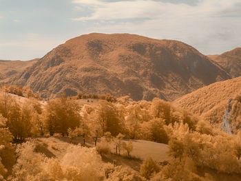 Scenic view of infrared landscape and mountains against sky