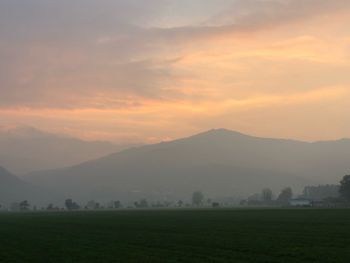 Scenic view of field against sky during sunset