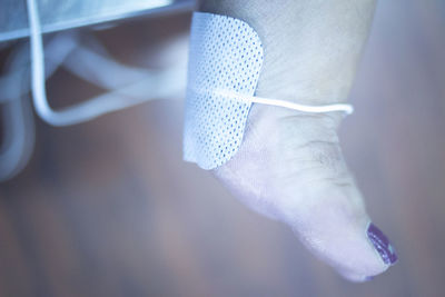 Low section of woman with medical equipment at hospital