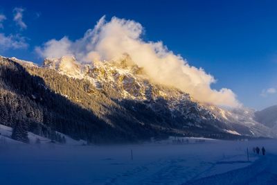 Scenic view of mountains against sky during winter