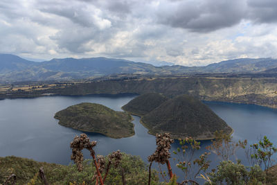 Scenic view of lake and mountains against sky