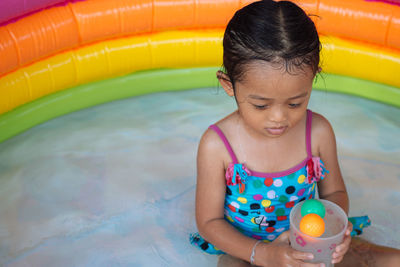 Girl playing in wading pool