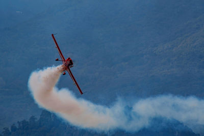 Low angle view of airplane flying against sky