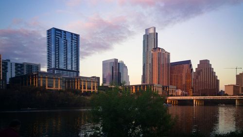 Low angle view of skyscrapers against sky during sunset