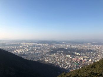 High angle view of cityscape against clear blue sky