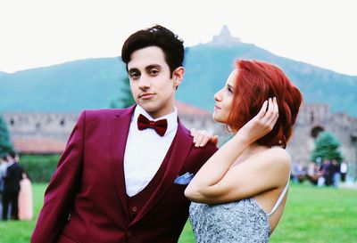 Portrait of young couple standing on mountain