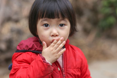Portrait of a vietnamese young little cute kid sucking her finger