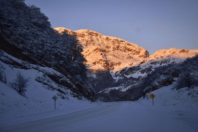 Scenic view of snow covered mountains against sky