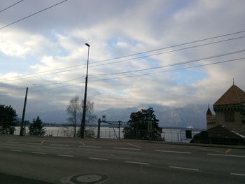 View of street against cloudy sky