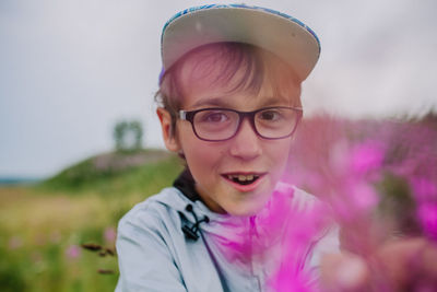 Portrait of man wearing eyeglasses on field