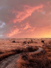 Scenic view of land against sky during sunset