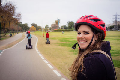 Portrait of woman riding bicycle on road