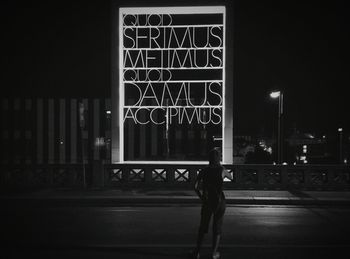 Man standing in illuminated city at night