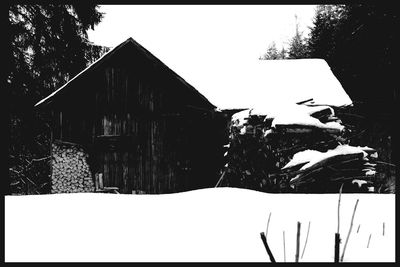 Low angle view of house against sky during winter