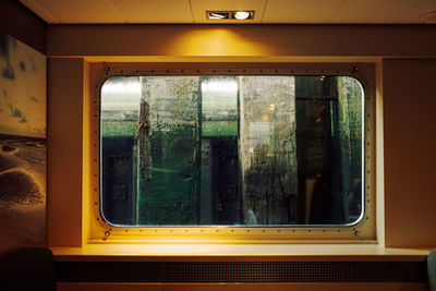 View through the window of a ship against wooden quay wall