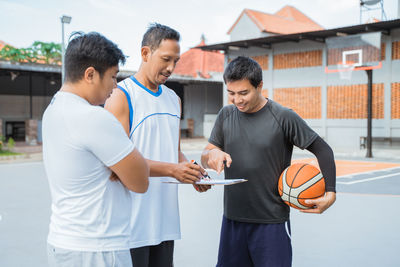 People standing on basketball court