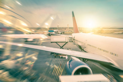 Close-up of airplane on runway against sky