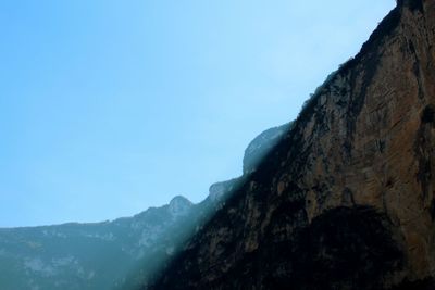 Low angle view of mountains against clear blue sky