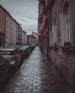 Street amidst buildings in city against sky