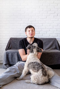 Portrait of a dog sitting on sofa