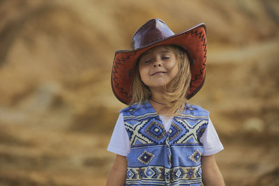 Portrait of woman wearing hat standing outdoors