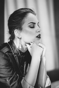 Young woman looking away at home