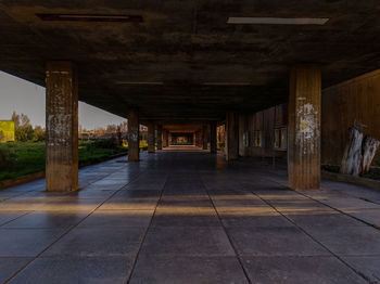 Empty walkway below bridge