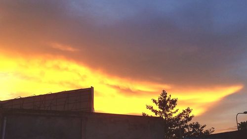 Low angle view of silhouette building against sky during sunset