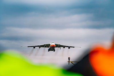 Low angle view of airplane flying against sky