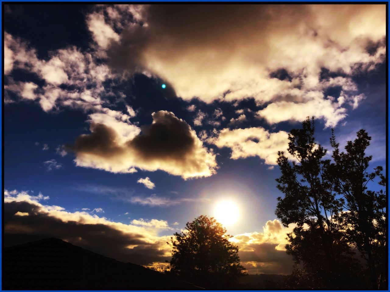 sky, cloud - sky, tree, beauty in nature, silhouette, tranquility, scenics - nature, sunlight, plant, sunbeam, nature, sunset, tranquil scene, no people, transfer print, sun, low angle view, outdoors, auto post production filter, idyllic, lens flare