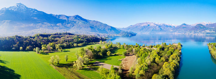 Scenic view of trees and mountains against blue sky