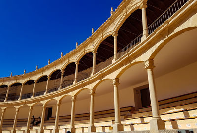 Low angle view of historic building against blue sky