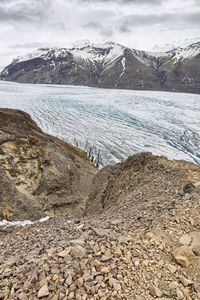 Scenic view of mountains and glacier against sky