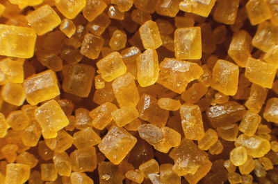 Extreme macro. sugar crystals. close-up of brown cane sugar on a plane. texture or background of