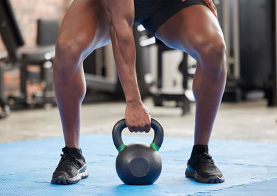 Low section of woman exercising in gym