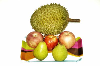 Close-up of fruits over white background