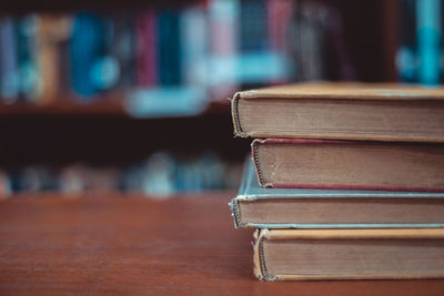Close-up of books on wooden table in library