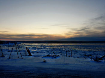 Scenic view of frozen sea against sky during sunset