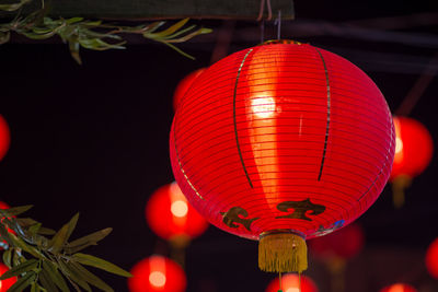 Low angle view of illuminated lanterns hanging at night