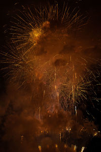 Low angle view of firework display at night