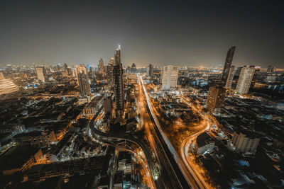 High angle view of illuminated city buildings at night