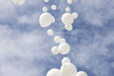 Low angle view of balloons against sky