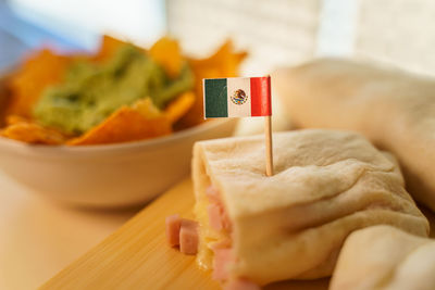 Close-up of hand holding food on table