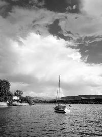 Sailboat sailing on sea against sky